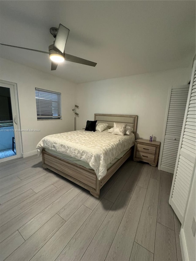 bedroom with light wood-type flooring and ceiling fan