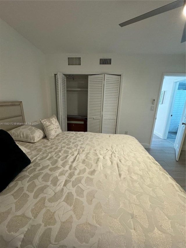 bedroom with wood-type flooring, a closet, and ceiling fan