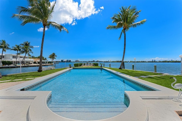 view of swimming pool with a lawn and a water view