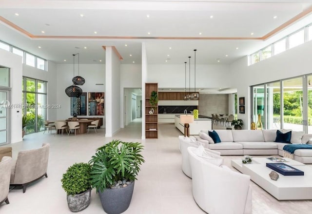 living room featuring a towering ceiling