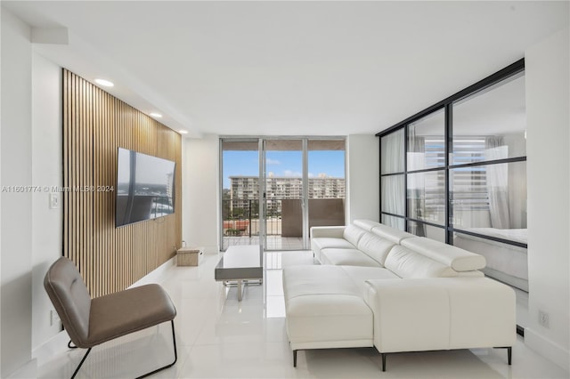 living room with floor to ceiling windows and tile flooring