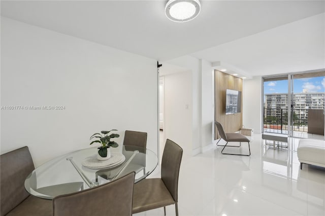 dining room with tile patterned floors and a wall of windows