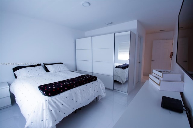 tiled bedroom featuring a closet