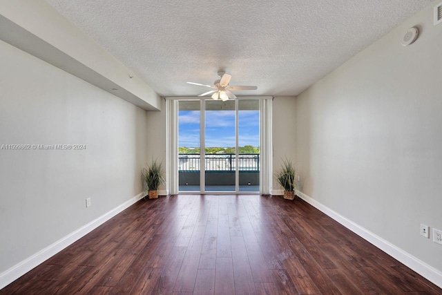 unfurnished room with dark hardwood / wood-style floors, a textured ceiling, floor to ceiling windows, and ceiling fan