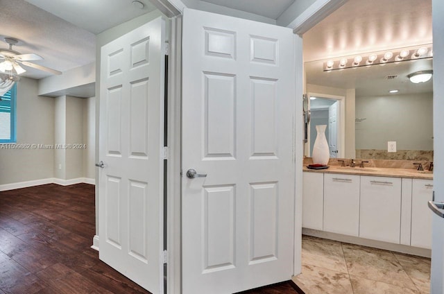 bathroom with ceiling fan, vanity, and wood-type flooring