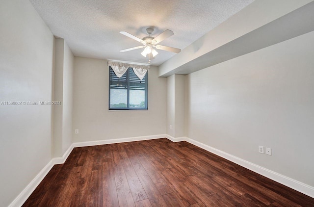 spare room featuring ceiling fan, dark hardwood / wood-style floors, and a textured ceiling