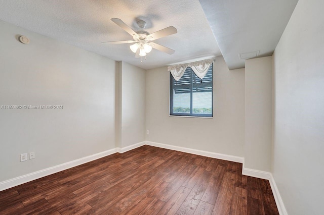 spare room featuring ceiling fan, dark hardwood / wood-style floors, and a textured ceiling