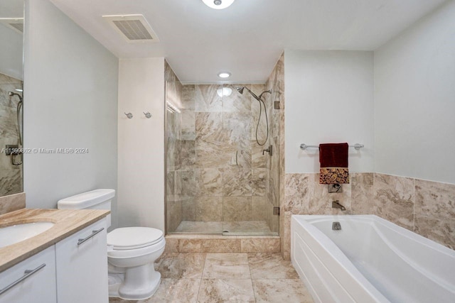 full bathroom featuring vanity, shower with separate bathtub, and toilet