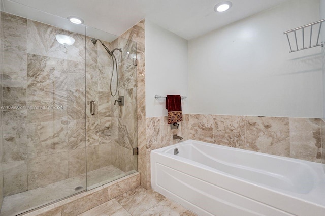 bathroom featuring separate shower and tub