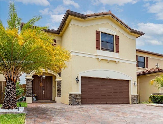 mediterranean / spanish-style house with a garage