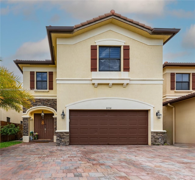 mediterranean / spanish-style home featuring a garage