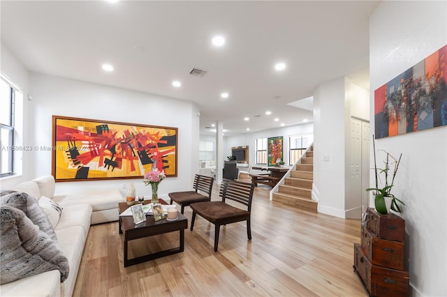 living room with plenty of natural light and light hardwood / wood-style flooring