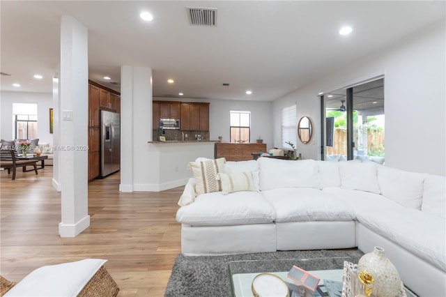 living room featuring plenty of natural light and light hardwood / wood-style floors