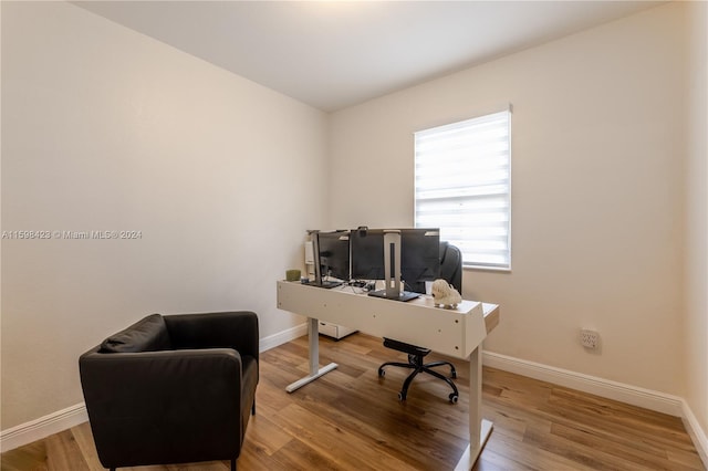 home office with hardwood / wood-style flooring