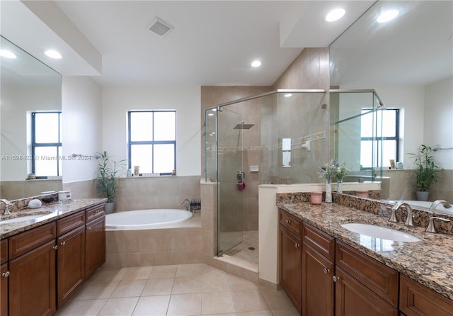 bathroom featuring shower with separate bathtub, tile patterned floors, and vanity