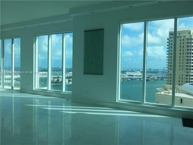 900 Brickell Key Blvd Unit 2803, Miami, FL 33131 - tiled empty room with a city view, healthy amount of natural light, and a water view
