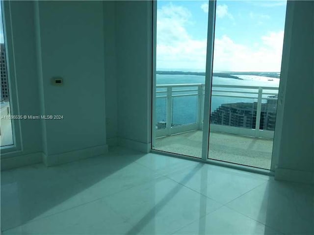 900 Brickell Key Blvd Unit 2803, Miami, FL 33131 - unfurnished room with a water view and tile patterned flooring