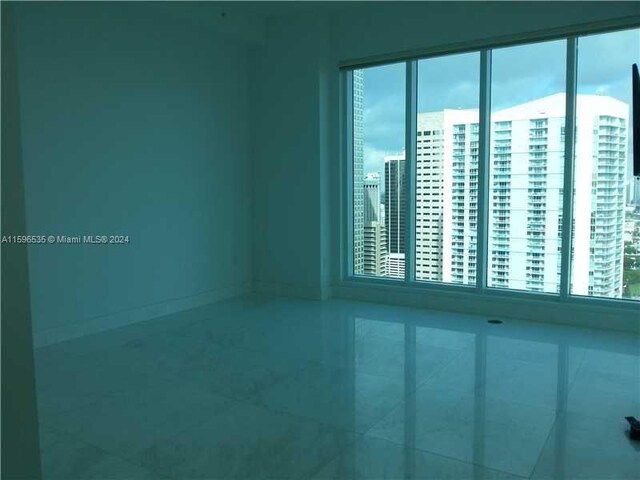 900 Brickell Key Blvd Unit 2803, Miami, FL 33131 - empty room featuring baseboards and tile patterned flooring