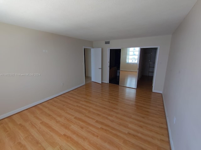 spare room with light wood-type flooring