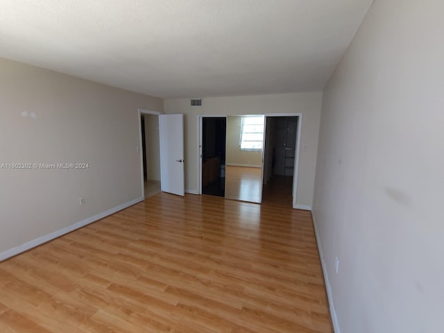 empty room with light hardwood / wood-style floors