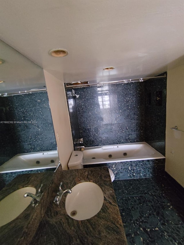 bathroom with tiled shower / bath combo and sink