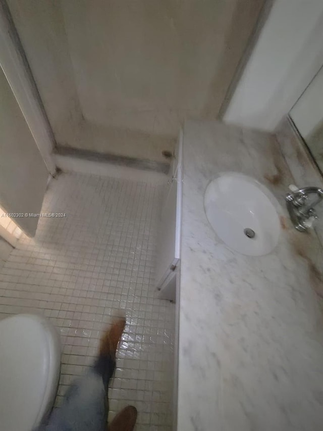 bathroom with tile patterned floors, vanity, and toilet