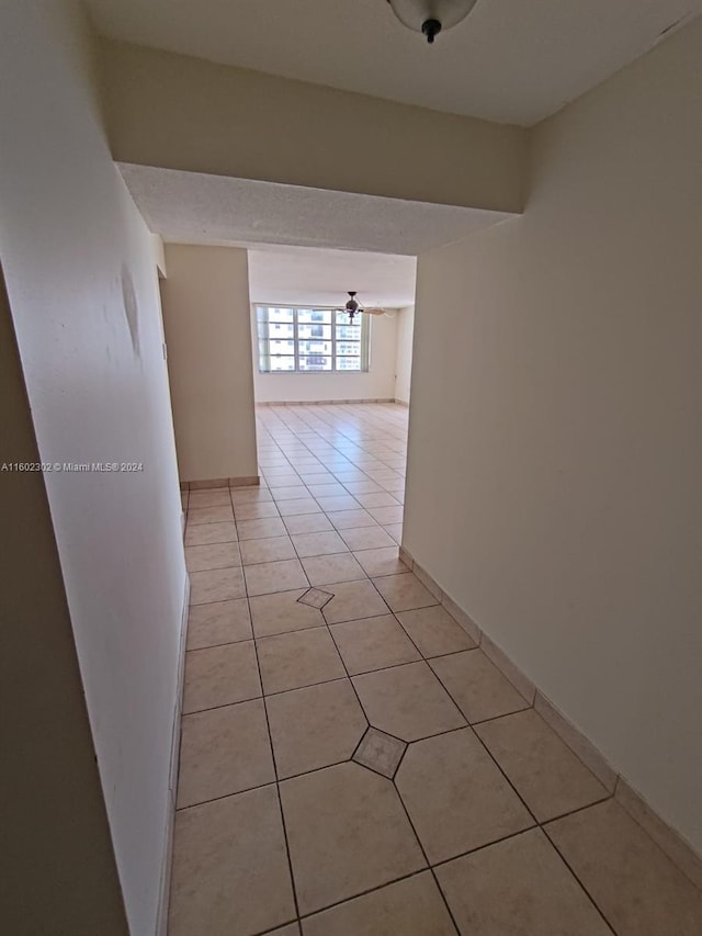 corridor with light tile patterned flooring