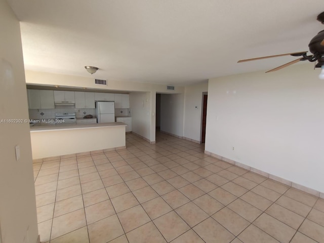 unfurnished living room with ceiling fan and light tile patterned floors