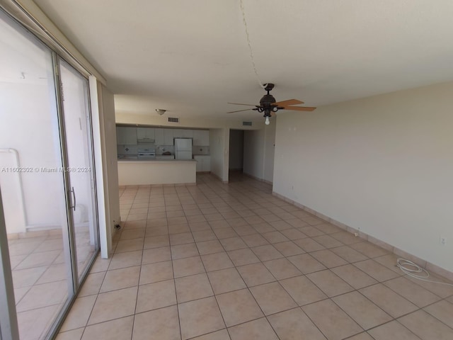 unfurnished living room with ceiling fan and light tile patterned flooring