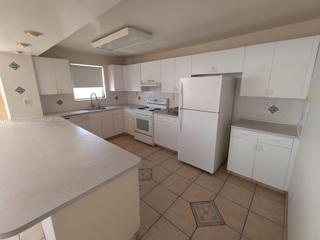 kitchen with white appliances, tasteful backsplash, white cabinetry, and sink