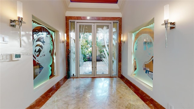 entryway with ornamental molding and french doors