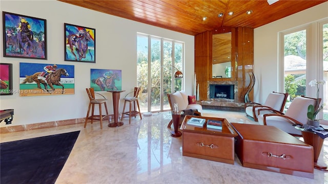 living room with a premium fireplace and wooden ceiling