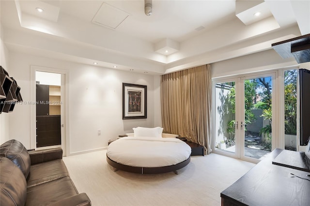 living room featuring a raised ceiling and french doors