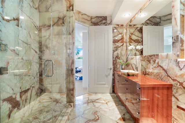 bathroom featuring vanity, an enclosed shower, and tile walls