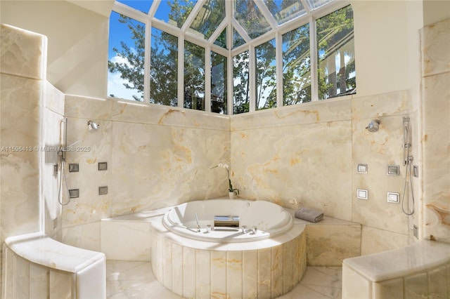 bathroom featuring shower with separate bathtub and tile walls