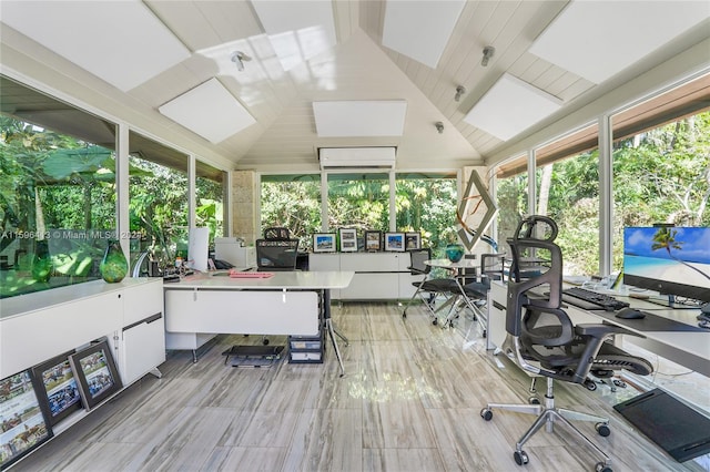 interior space with high vaulted ceiling, a wall unit AC, and a wealth of natural light