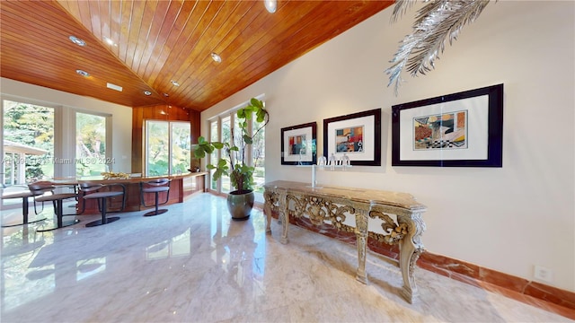 corridor featuring wooden ceiling and high vaulted ceiling