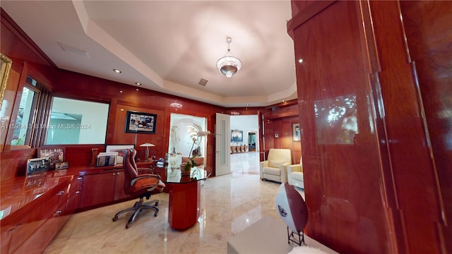 home office featuring a raised ceiling