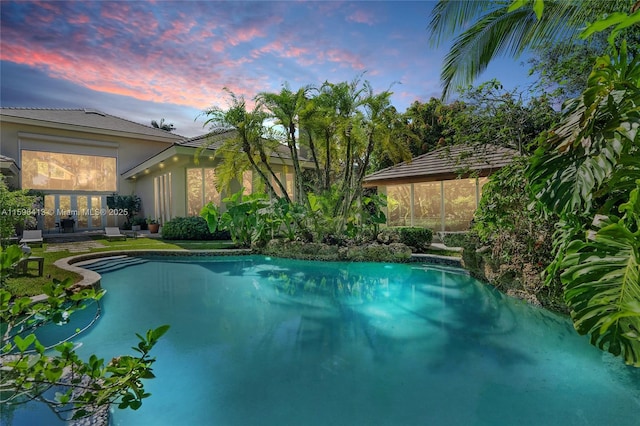 view of pool at dusk