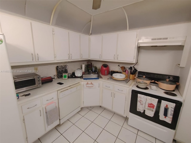 kitchen with light tile patterned floors, white cabinets, white appliances, and sink