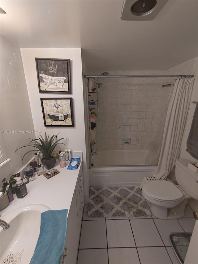 full bathroom featuring toilet, tile patterned flooring, shower / bath combination with curtain, and sink