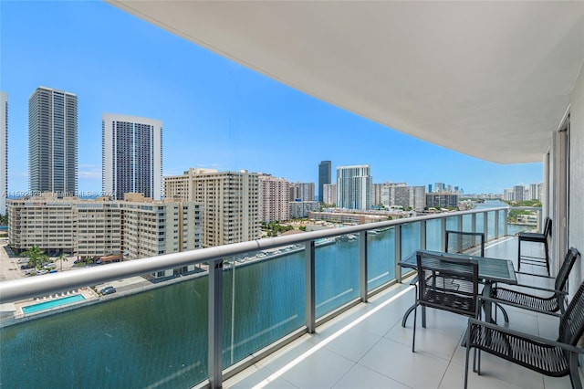 balcony with a water view and a city view