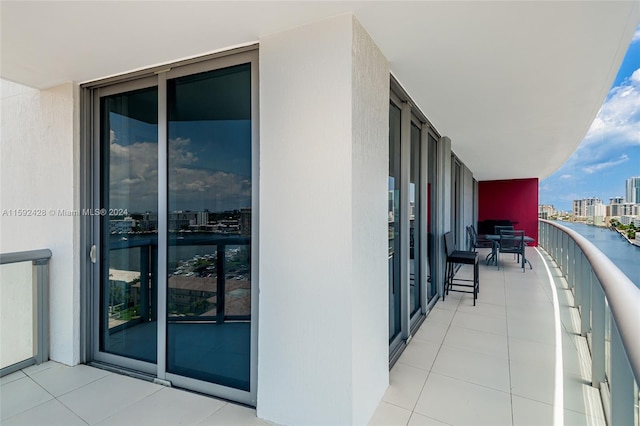 balcony with a water view and a city view