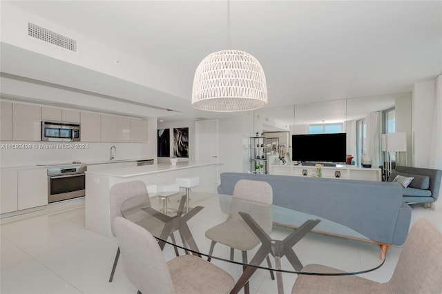 dining area with light tile patterned flooring and visible vents