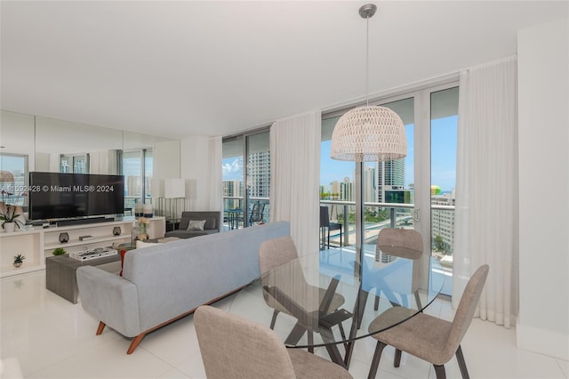 living area with expansive windows, plenty of natural light, tile patterned flooring, and a city view