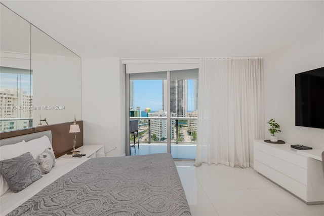 bedroom with tile patterned flooring and a city view