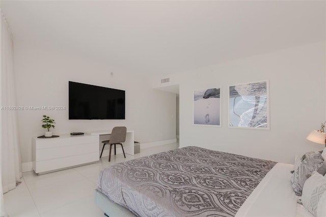 tiled bedroom featuring baseboards and visible vents