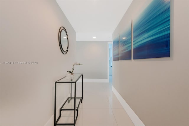 corridor with recessed lighting, tile patterned flooring, and baseboards