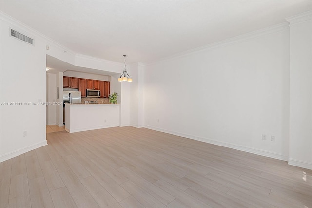 unfurnished living room with light wood-type flooring, crown molding, and an inviting chandelier