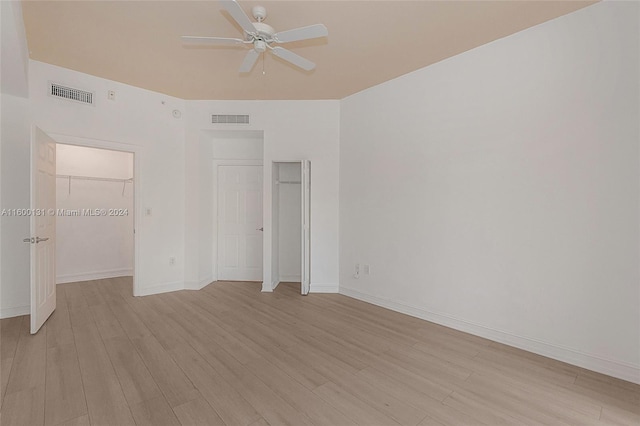 unfurnished bedroom featuring light wood-type flooring and ceiling fan